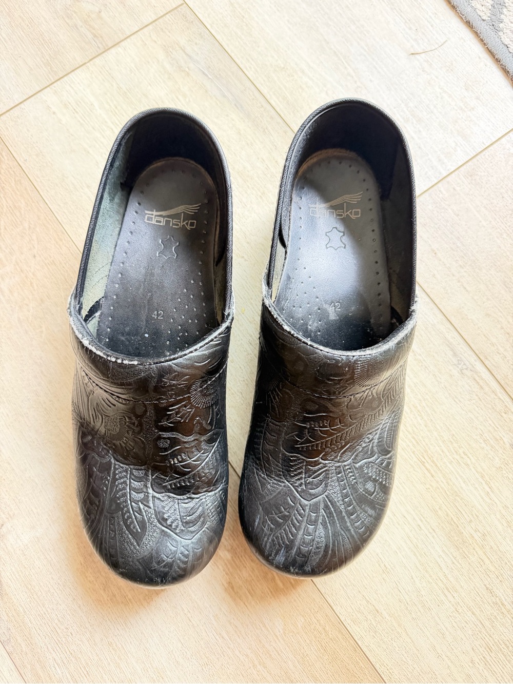 Dansko Woman’s Black Embossed Slip-On Clogs